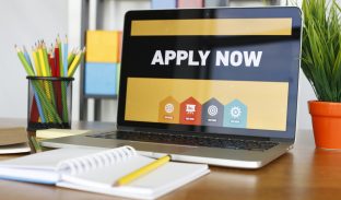laptop with apply now written on screen