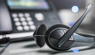 VOIP headset in front of a telephone