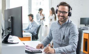 Happy Young Male Customer Support Executive Working In Office.