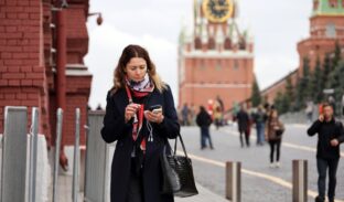 Moscow,,Russia,-,September,2022:,Woman,With,Smartphone,Walking,On